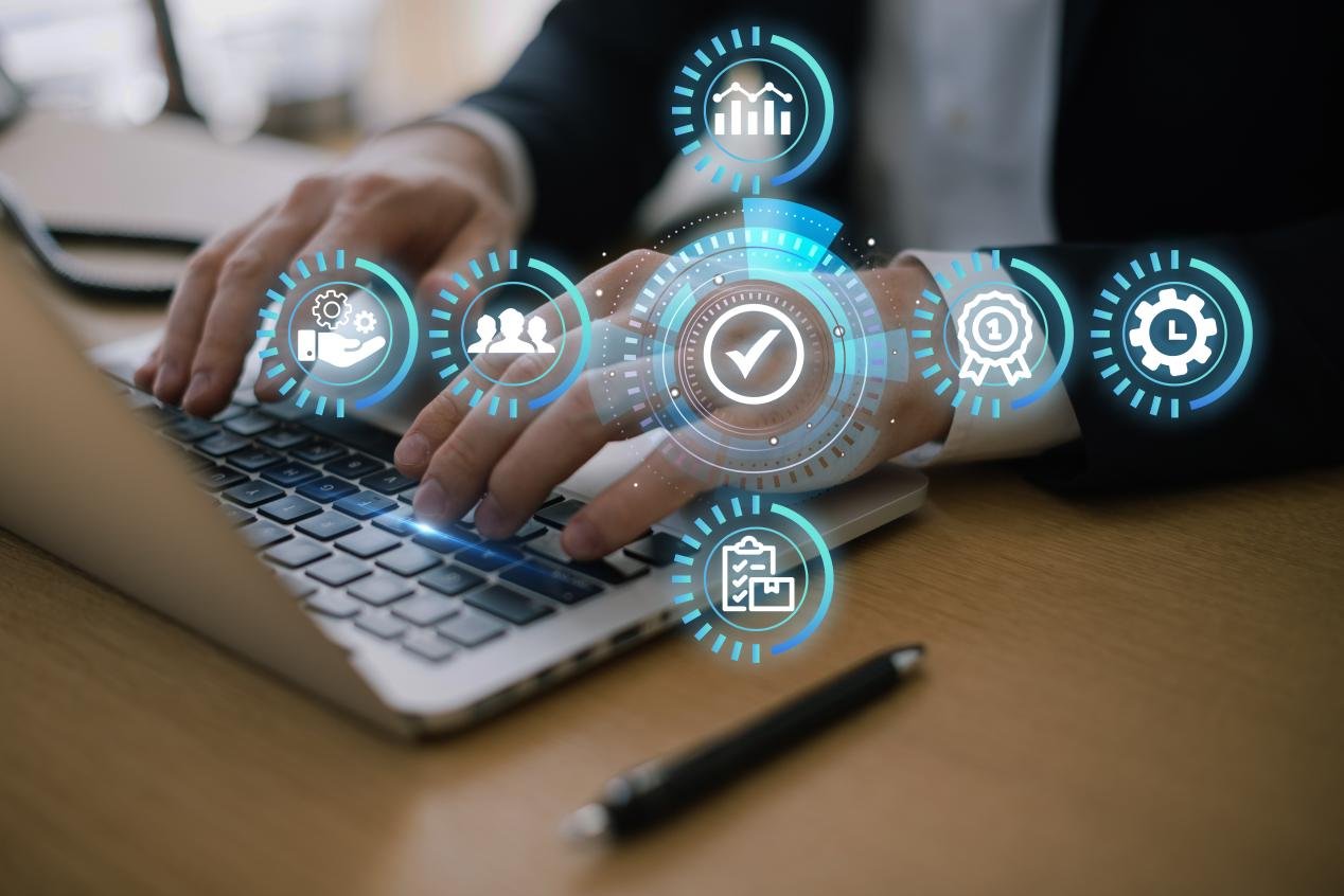 Man working on laptop, process automation shown in front.