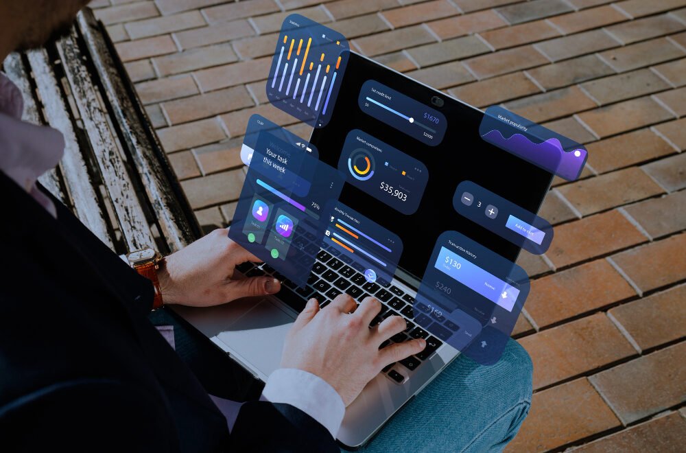 Man working on laptop, screen showing business software automation processes.